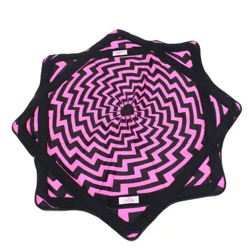Pink and black spiral patterned yoga mat with textured surface.