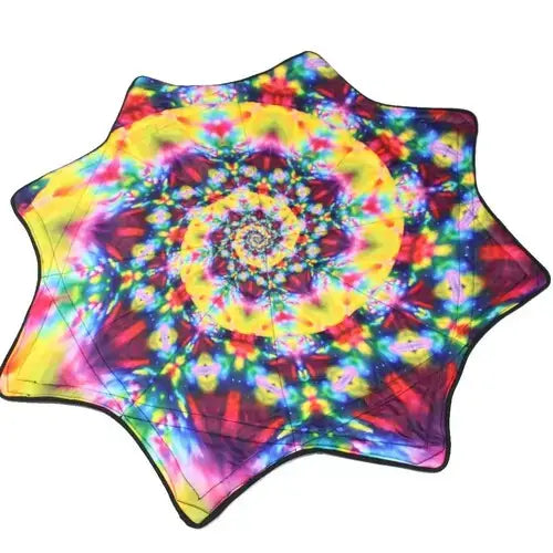 Tie-dye beach towel with vibrant spiral pattern and starburst edges.