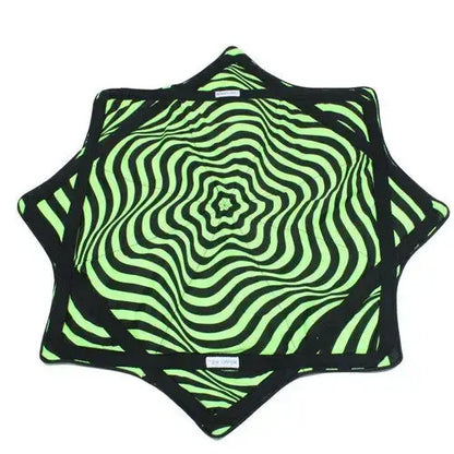 Neon green and black star-shaped blanket with swirling pattern, likely made of soft fabric.
