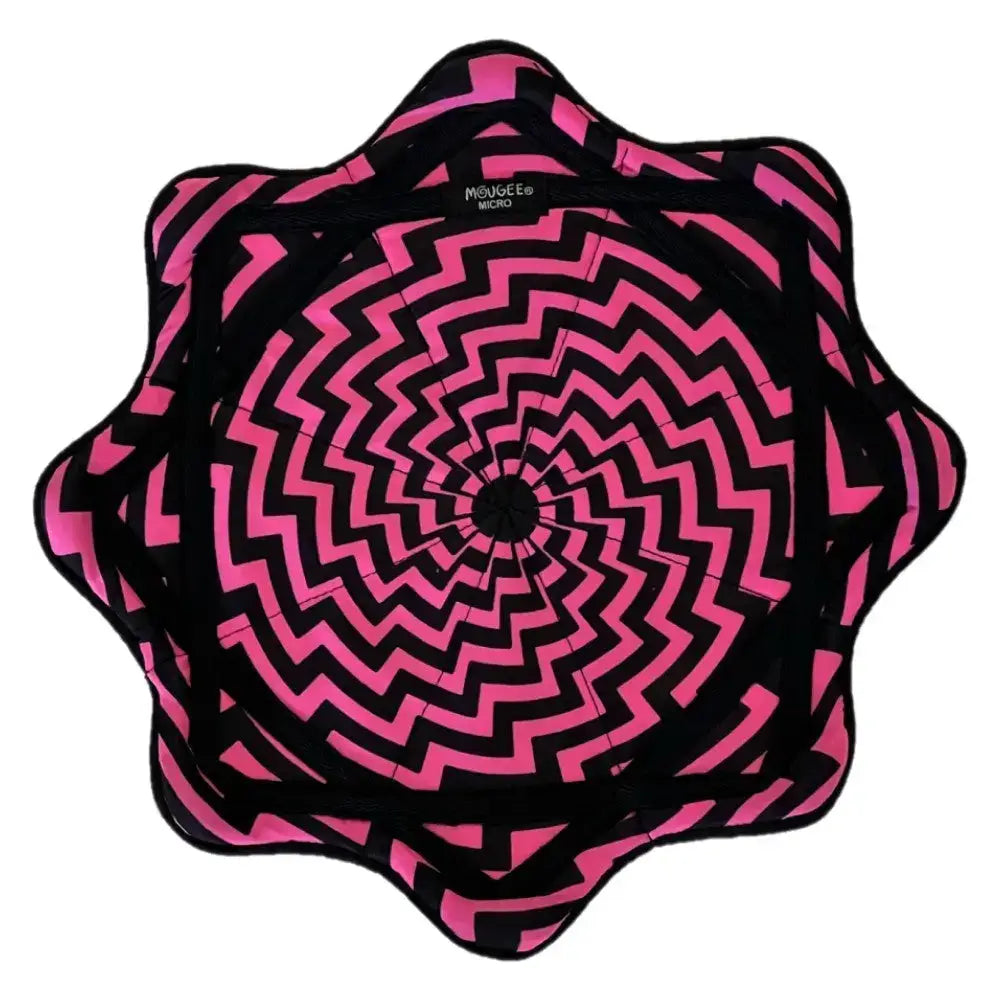 Black and pink spiral patterned fabric cushion with a starburst design.