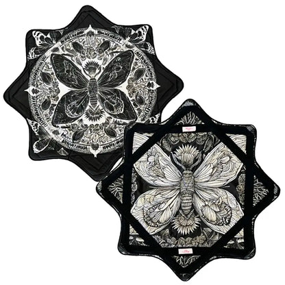 Black and white butterfly quilted potholder set with intricate designs.