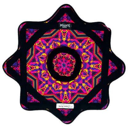 Star-shaped mandala cushion with vibrant purple and pink hues, black edges, and intricate floral patterns.